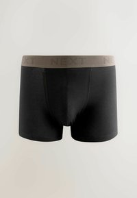 Boxer neri in cotone con una texture liscia, dotati di una cintura elastica beige imbossata con la scritta "NEXT" in un motivo ripetitivo.