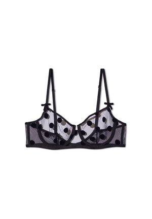 Reggiseno in rete nera trasparente con motivo a pois, supporto con stecche, spalline regolabili e fiocchi decorativi ai bordi delle spalline.