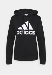 Felpa nera con cappuccio realizzata in misto cotone, con logo adidas bianco. Grafica triangolare dinamica sul petto, con stringhe di regolazione e polsini a coste.