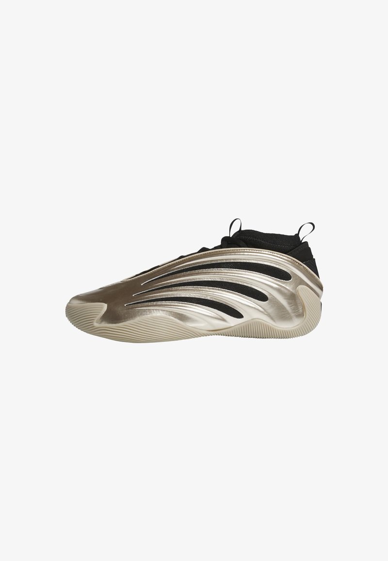 Sportlicher Schuh mit einem metallic goldenen und schwarzen Obermaterial, das elegante, geschwungene Linien aufweist. Die strukturierte Sohle bietet Halt mit einem gemusterten Design.