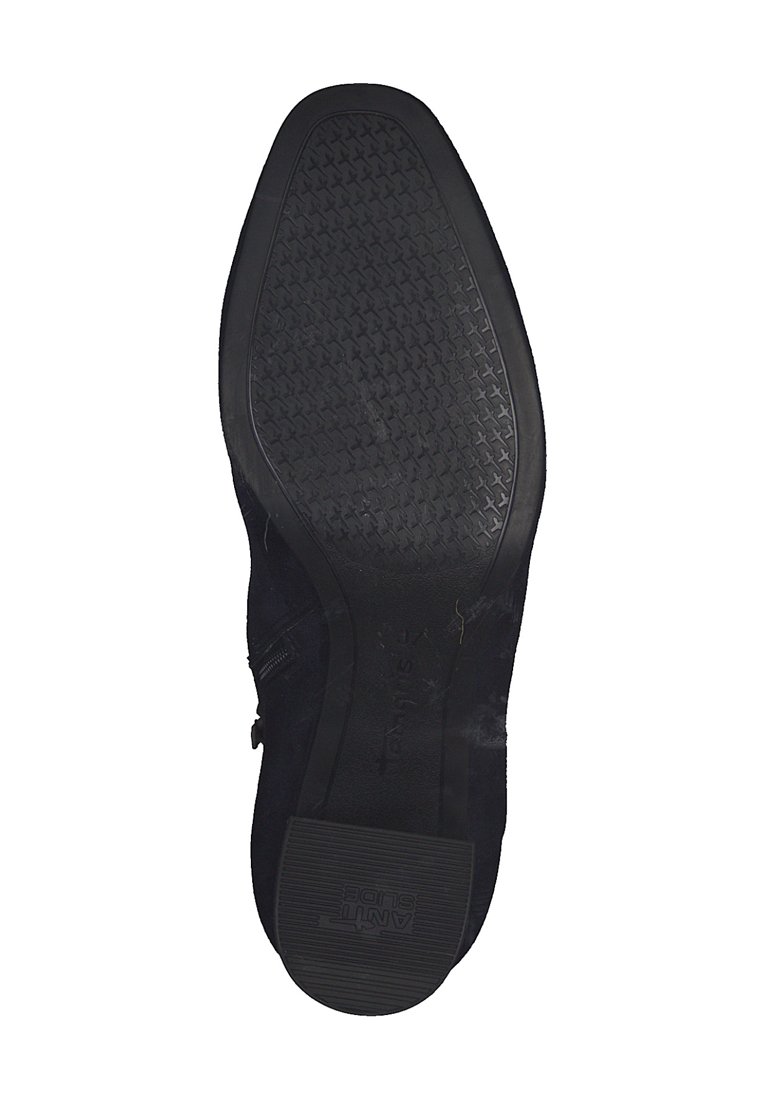 Suola nera di una scarpa elegante con battistrada testurizzato e "ANTI-SLIDE" impresso sul tallone per resistenza allo scivolamento.