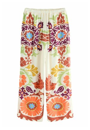 Pantalons à jambes larges en tissu léger présentant un motif floral avec des accents orange, vert, violet et bleu sur un fond crème.