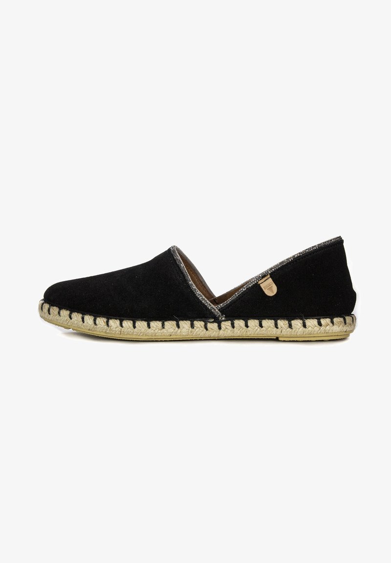 Zapato negro de ante sin cordones con suela de yute trenzado, acentos plateados a lo largo de la abertura y una pequeña etiqueta con el logo en el costado.