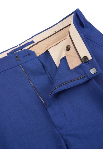 Blue dress pants with beige inner lining, partially unzipped zipper, two black buttons on the waistband, and metal hook closure.