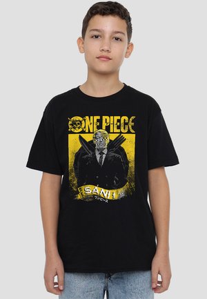 Black cotton t-shirt featuring a yellow and white graphic design of a character with knives, labeled "ONE PIECE SANI," worn with blue jeans.