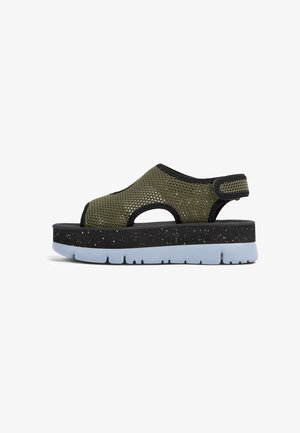 Mesh sandal with olive green upper, black accents, and speckled dark platform. Features a slip-on design with open toe and heel for ventilation.