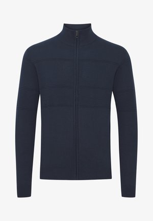 Cardigan cu fermoar de culoare bleumarin, cu panouri texturate și manșete ribbate. Dispune de un guler înalt și o siluetă ajustată. Material tricotat moale.