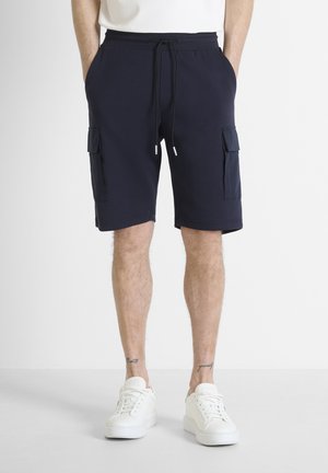 Marine cargoshorts van zacht stof, met twee zijzakken en een verstelbare trekkoord taille, gecombineerd met witte sneakers.