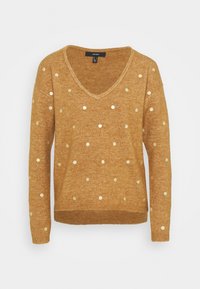 Senapsgul tröja med V-ringning, långa ärmar och gyllene prickmönster. Tillverkad av mjukt material, med ribbade muddar och nederkant.