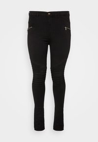 Vaqueros pitillo negros con bolsillos frontales con cremallera, diseño acanalado en la parte superior del muslo y tejido elástico, con una textura suave y una silueta ajustada.