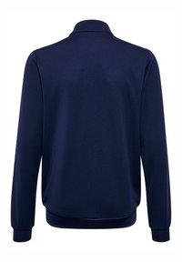 Marineblauw polojack met een gestructureerde stof, voorzien van een kraag en lange mouwen. De manchetten en zoom zijn geribd voor een aansluitende pasvorm.