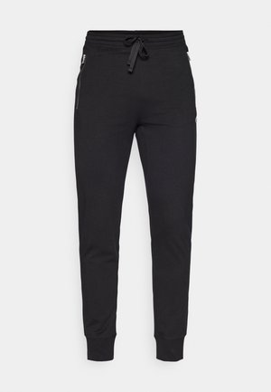 Zwarte sweatpants van een zachte stof, met een elastische tailleband en een trekkoord, zijzakken met rits en ribbels aan de mouwen.
