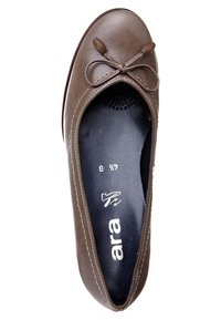 Brown leather ballet flat with a rounded toe, decorative bow, and contrasting stitching. Interior features a padded insole for comfort.
