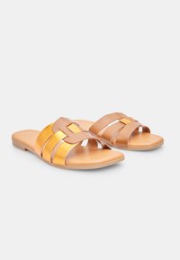 Sandali slide marroni e dorati con molteplici cinturini sovrapposti, texture liscia e suole piatte, progettati per una facile calzata e comfort.