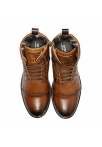 Bottines en cuir marron avec lacets et fermetures éclair, dotées d'une finition lisse et d'une doublure en tartan. Comprend le logo de la marque sur la languette.