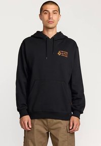 Black hooded sweatshirt with front kangaroo pocket, drawstring, and orange branded logo on the left chest. Soft fabric texture.