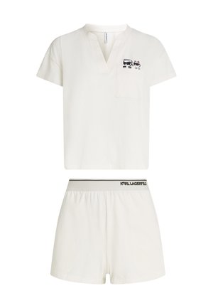 White two-piece loungewear set with short-sleeve top featuring cartoon cats and matching shorts with "Karl Lagerfeld" waistband.