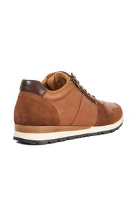 Brown leather and suede sneaker with a round toe, lace-up design, and a white midsole. Features a padded collar and side accents.
