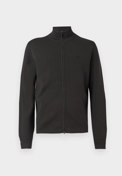 Μαύρο φλις μπουφάν με φερμουάρ, γιακά που στέκεται όρθιος, δύο μπροστινές τσέπες και διακριτικό κεντημένο λογότυπο στο αριστερό στήθος.