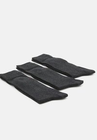 Drei Paare dunkelgrauer Socken aus einem weichen Material, mit einem gerippten Bündchen und einer glatten Textur, ordentlich zum Ausstellen aufgerollt.