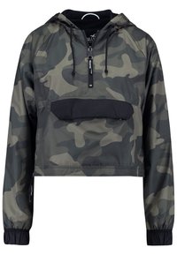 Cazadora cortada de camuflaje en tonos de verde y negro, con un bolsillo frontal, cierre de media cremallera y puños elásticos. Material ligero.