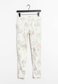 Blommiga skinny jeans med en ljus bakgrund som har rosa och gröna blad. Tillverkade av denim, de har framfickor och bälteshällor.