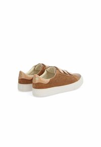 Brown suede sneakers with textured leather accents, velcro straps, and perforated detailing on the sides. White rubber soles.