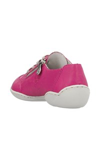 Pink leather shoe with a rounded shape, white rubber sole, and metallic zipper detail on the side. Smooth texture with subtle design accents.
