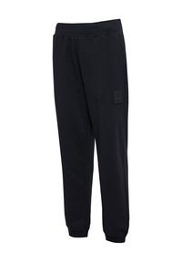 Schwarze Jogginghose mit glatter Textur, elastischem Bund und zulaufenden Beinen. Verfügt über ein kleines Markenpatch auf der linken Seite.