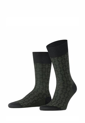 Dark green socks with a geometric pattern, featuring a ribbed black cuff and solid black toe and heel sections.