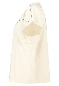 T-shirt beige clair à manches courtes, avec des clous métalliques le long des coutures d'épaules, en coton doux et à coupe décontractée.
