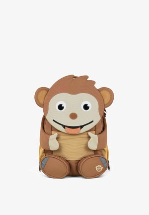 Brown monkey-shaped children's backpack with big eyes, sticking out tongue, beige hands and feet, and front mesh pocket.