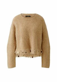 Beige, kurz geschnittenen Pullover aus flauschigem Material, mit Fransen am Saum und dekorativen runden Akzenten entlang des unteren Randes. Schlichter Rundhalsausschnitt.