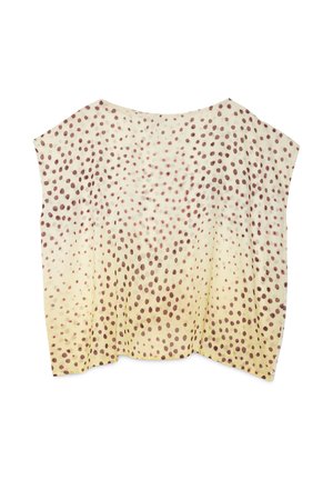 Haut sans manches ample avec un fond crème et des pois marron éparpillés, passant denses en haut à clairsemés en bas.
