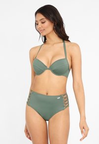 Green bikini set featuring a padded underwire top with adjustable straps and high-waisted bottoms with side lace-up detailing.