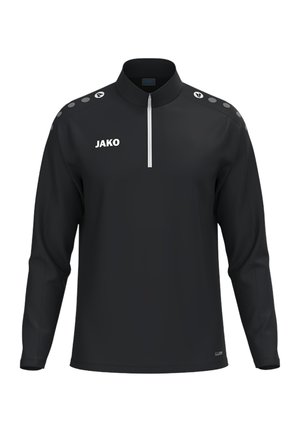 Schwarzes Sporttop mit langen Ärmeln, weißem Viertelreißverschluss, JAKO-Logo auf der linken Brustseite und gemusterten Schulterakzenten auf beiden Seiten.