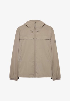 Kevyt beige takki hupulla, edessä vetoketjusuljenta, elastiset hihansuut ja kaksi sivutaskua. Sisältää sinistä ommelta ja logon hihassa.