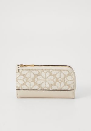 Beige wallet featuring a textured fabric panel with a floral pattern, gold zipper, and smooth leather bottom. Compact rectangular shape.