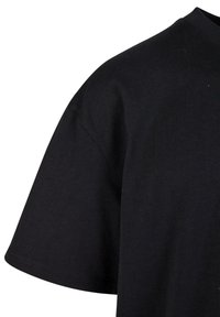 Black cotton T-shirt with short sleeves, round neckline, and a relaxed fit. Smooth texture with no visible patterns or embellishments.