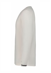 Langærmet skjorte i lys beige, lavet af blødt stof. Har rund hals og en sort accentstribe ved manchetterne. Enkel, lige skåret design.