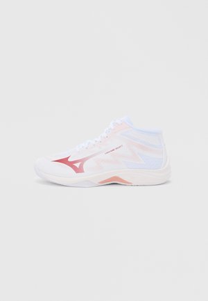 High-top athletic shoes in white with pink accents. Features mesh and synthetic materials, a textured surface, and a cushioned sole.
