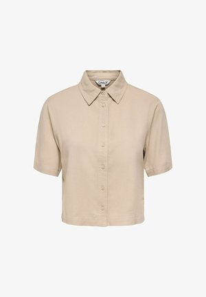 Beżowa krótka koszula na guziki z krótkim rękawem, krótkim krojem, szpiczastym kołnierzykiem, lekkim materiałem oraz metką marki wewnątrz kołnierza.