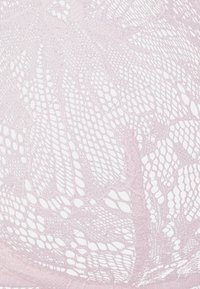 O tecido rendado em rosa claro apresenta delicados padrões florais e intrincados detalhes de rede, realçando sua textura suave e aparência translúcida.