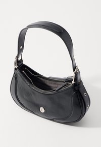 Black leather handbag with a curved design, zippered closure, and silver hardware accents. Features a sturdy strap and lined interior.