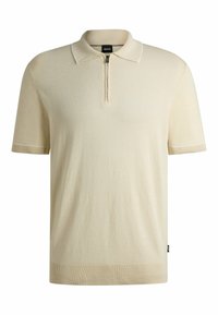Beige kortärmad polo med dragkedja i halsen, ribbade ärmslut och nederkant, med subtila kontrasterande sömmar.