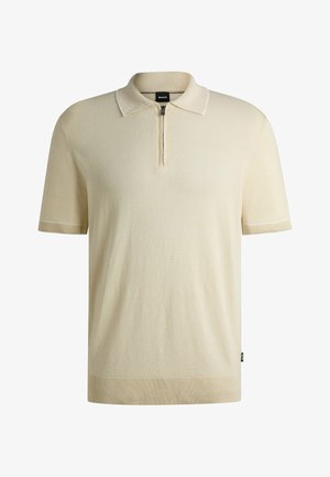 Beige short-sleeve polo shirt with a zippered neckline, ribbed cuffs, and hem, featuring subtle contrasting stitching details.