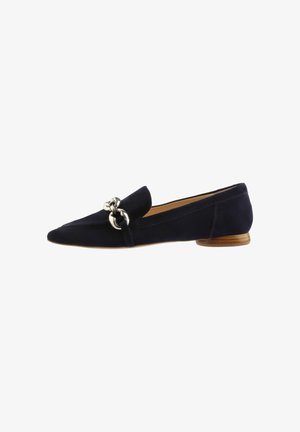 Navy suede flat shoe with pointed toe, low wooden heel, and metallic ring hardware accent on upper. Smooth texture and sleek design.