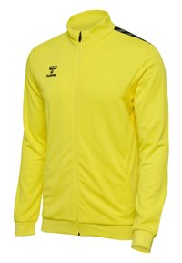 Żółta kurtka na zamek błyskawiczny o teksturowanym wykończeniu, z czarnymi akcentami na ramionach, wysokim kołnierzem oraz dwoma bocznymi kieszeniami. Logo marki na piersi.