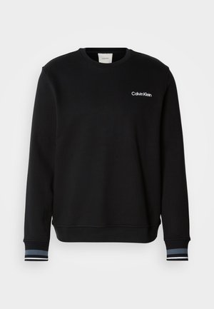 Svart sweatshirt i bomullsblandning, med rund halsringning, långa ärmar och kontrasterande randiga manschetter. Logotypen visas på bröstet.