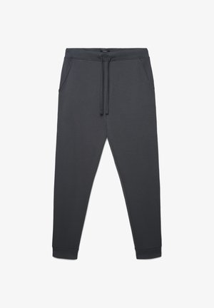 Pantaloni della tuta grigio scuro in tessuto morbido, con cintura elastica e coulisse, tasche laterali e polsini affusolati.